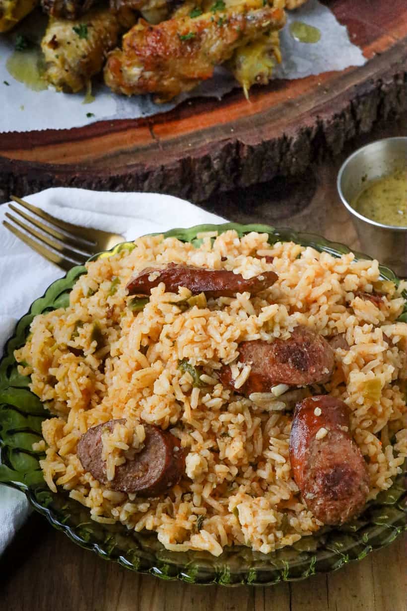 dirty rice with sausage in green plate