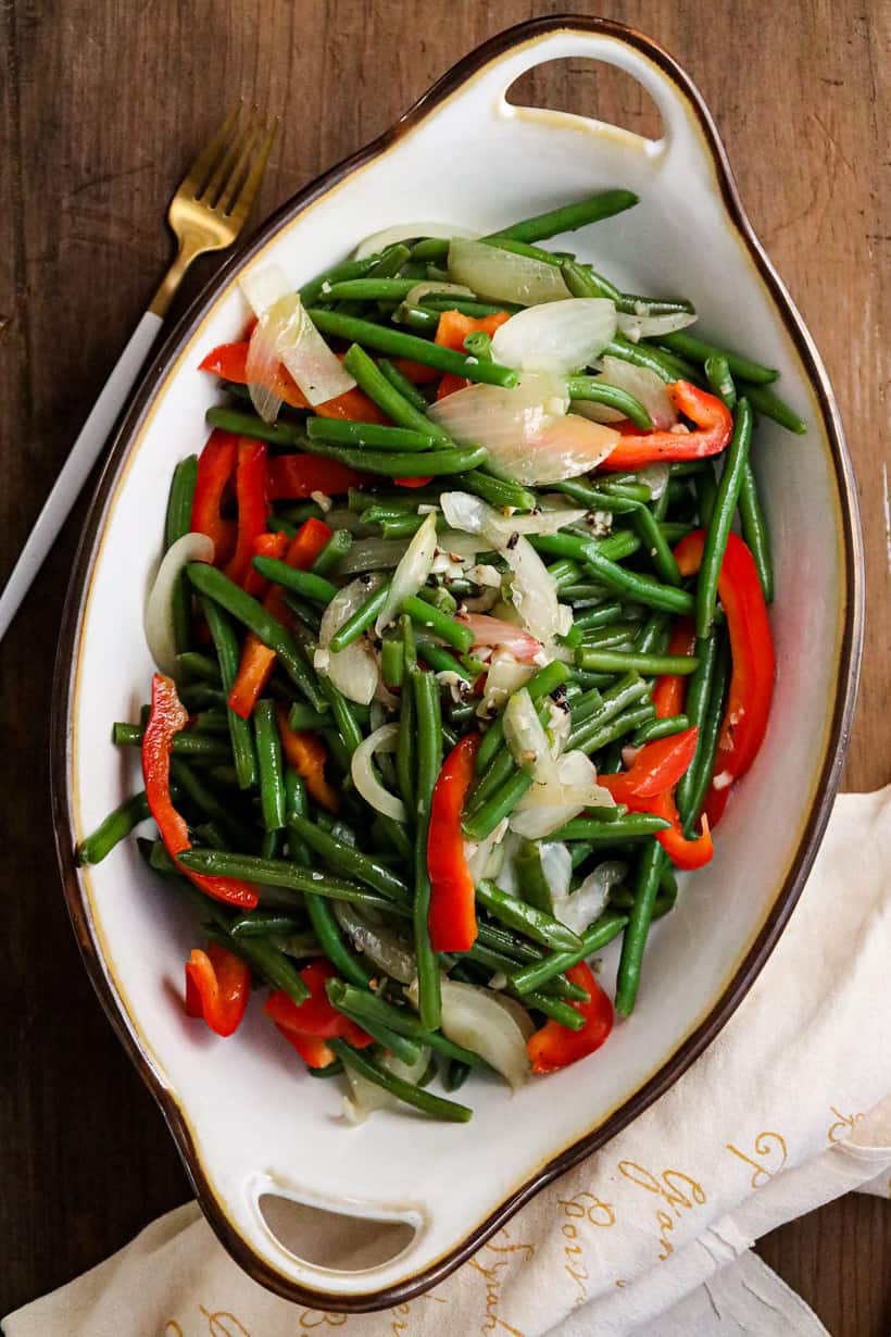 green beans with garlic and onions in white bowl