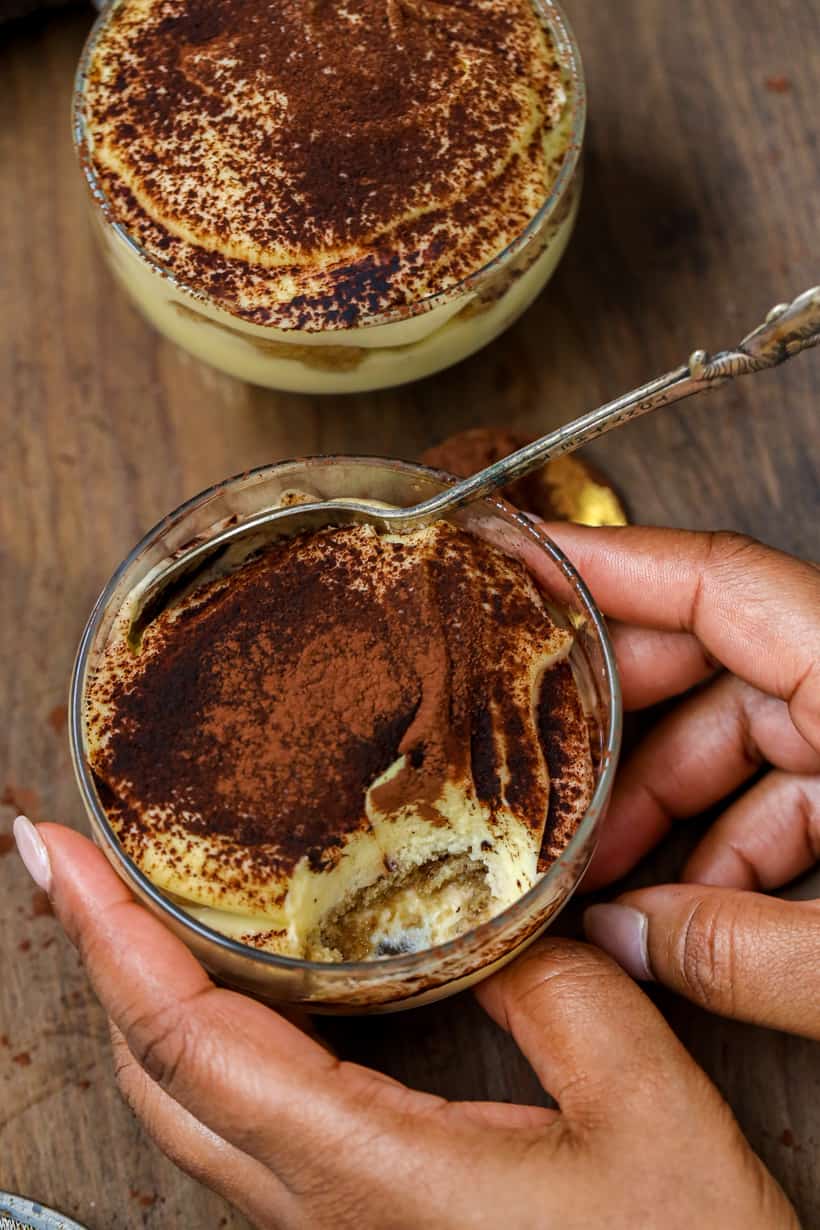hands holding Tiramisu cups