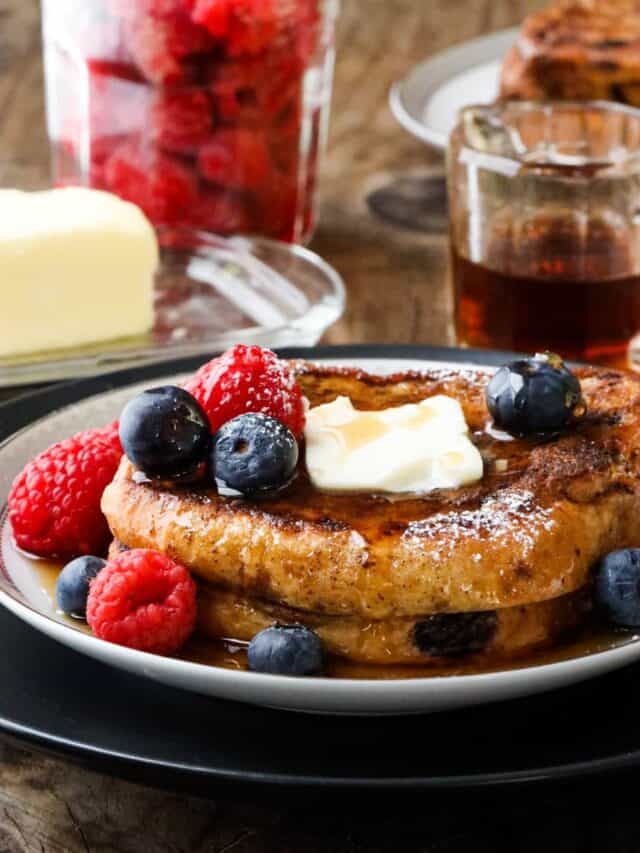 toast on white plate with fruits and butter