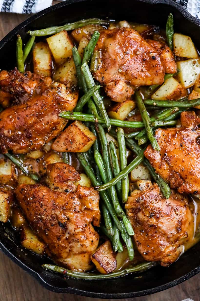 Cooked chicken thighs with honey mustard sauce in skillet