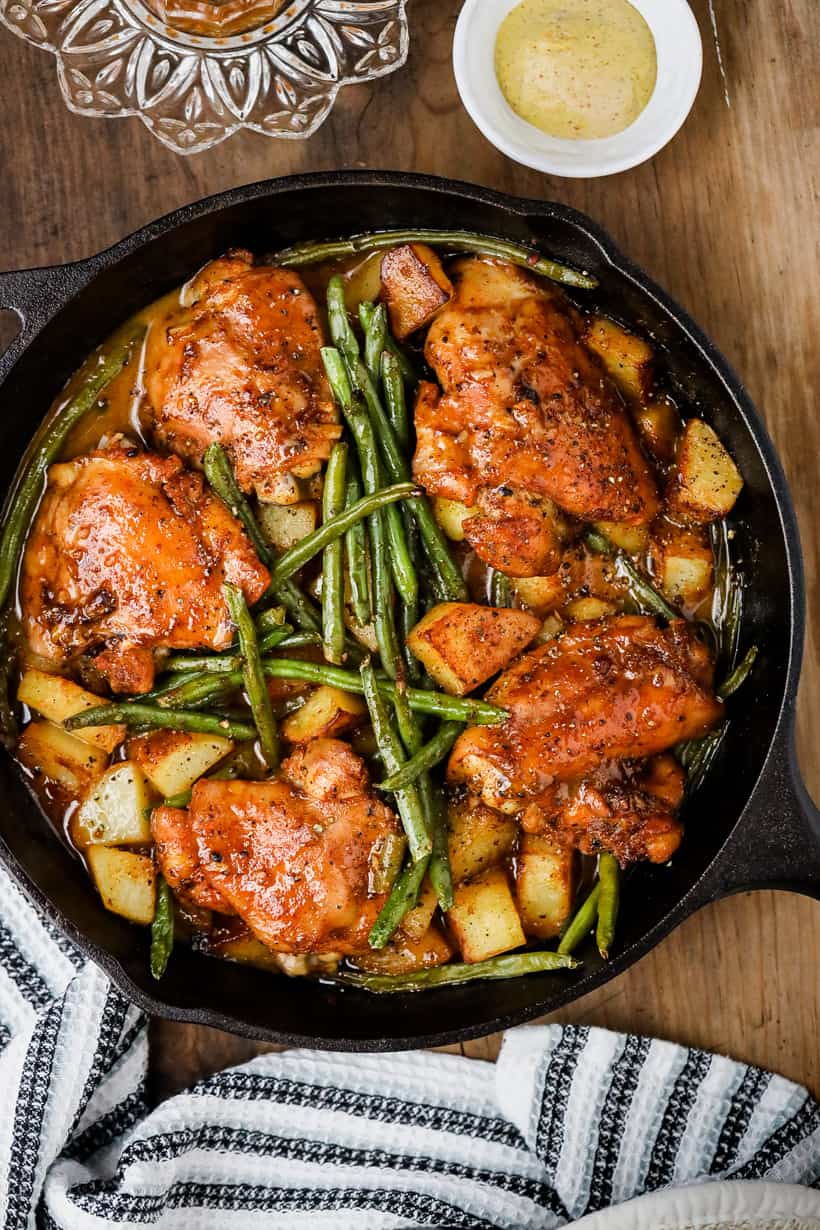 One pan honey mustard chicken, potatoes, and green beans in skillet.