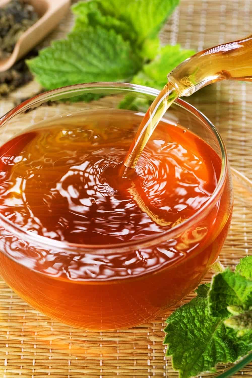 pouring tea in a glass tea cup