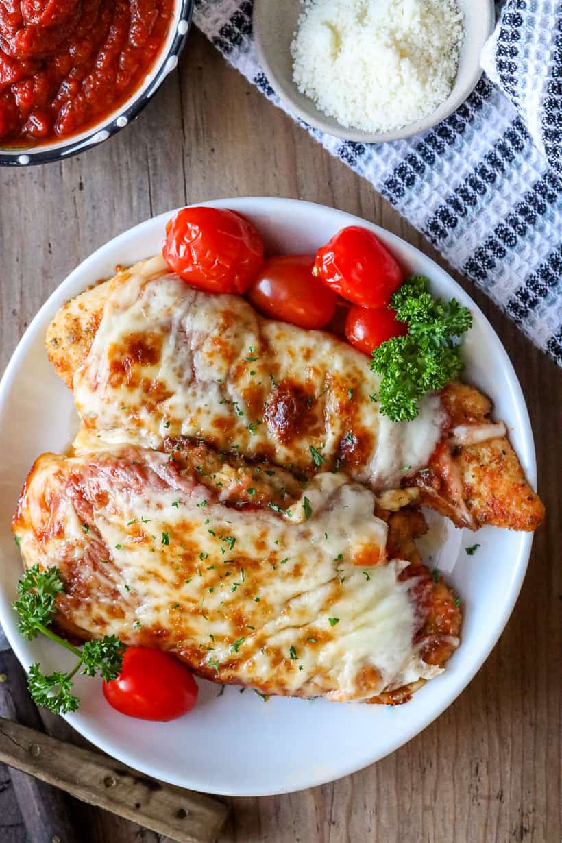 cooked chicken parmesan on white plate