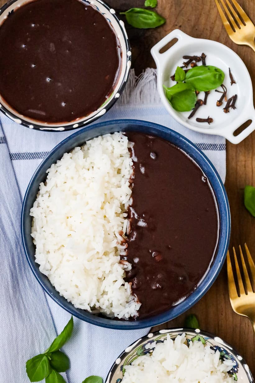 Haitian black beans sauce and rice in blue bowl