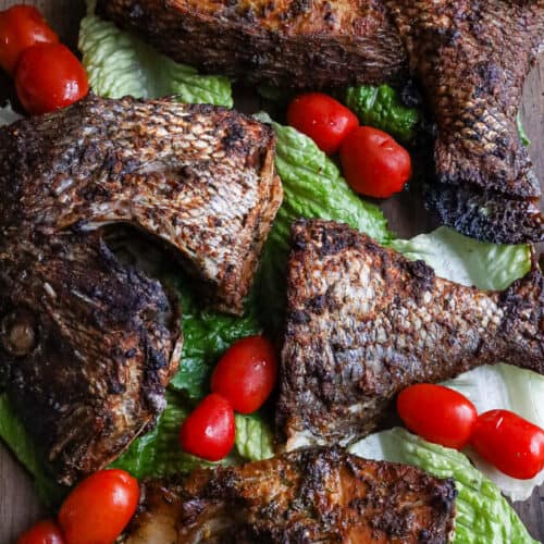 air fried porgy fish on a bed of lettuce and tomatoes