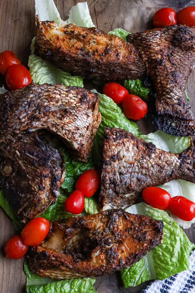 air fried porgy fish on a bed of lettuce and tomatoes