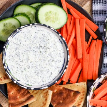 tzatziki dip in bowl on black plate
