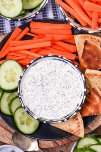 tzatziki sauce in bowl with vegetables.