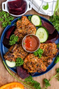 cooked lamb chops air fryer with sauce and veggies and herbs