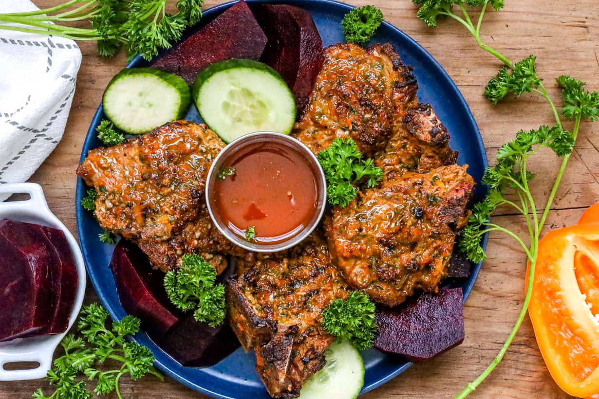 air fryer lamb chops with vegetables on blue plate