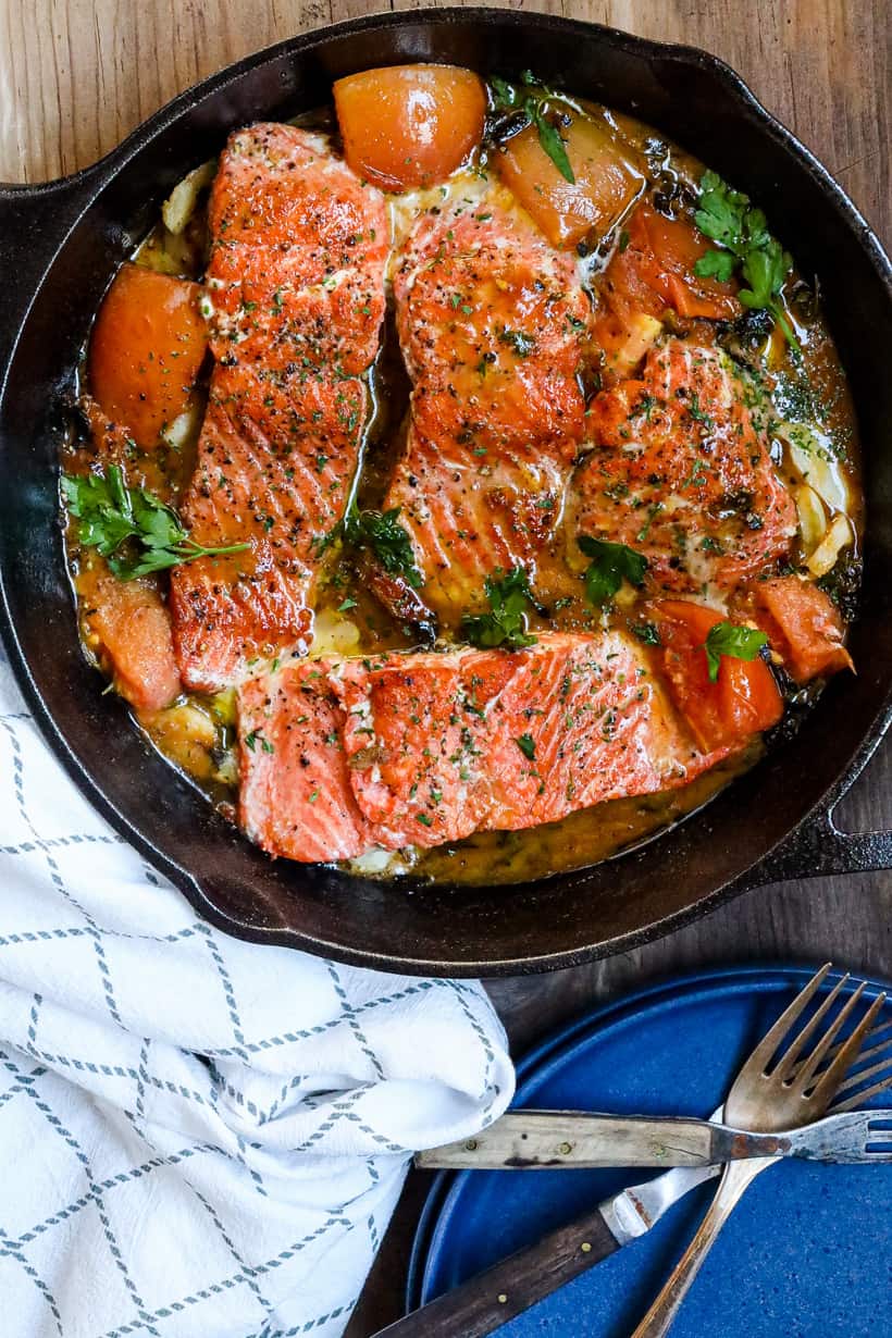 salmon with tomatoes in skillet