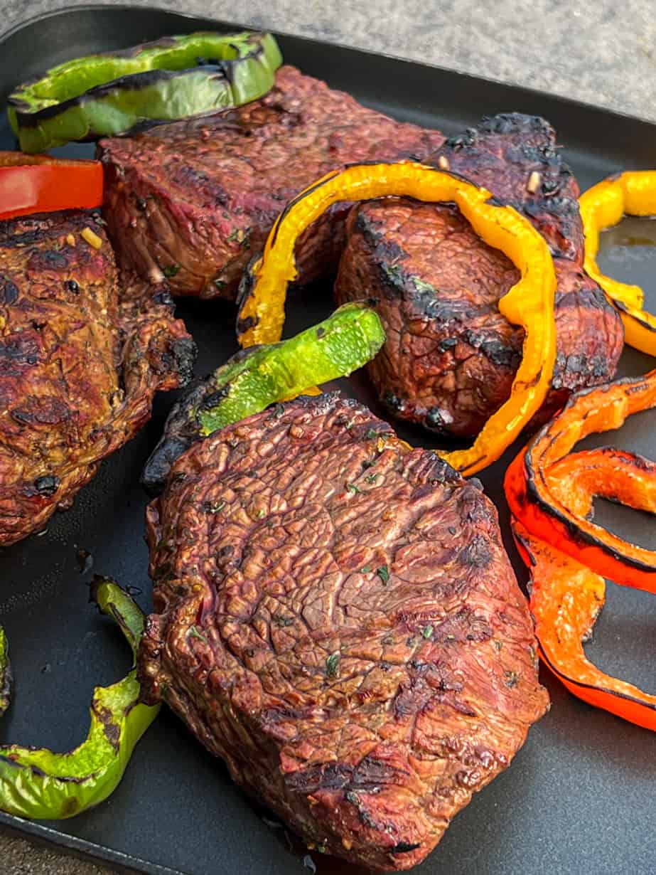cooked grilled sirloin steak and peppers