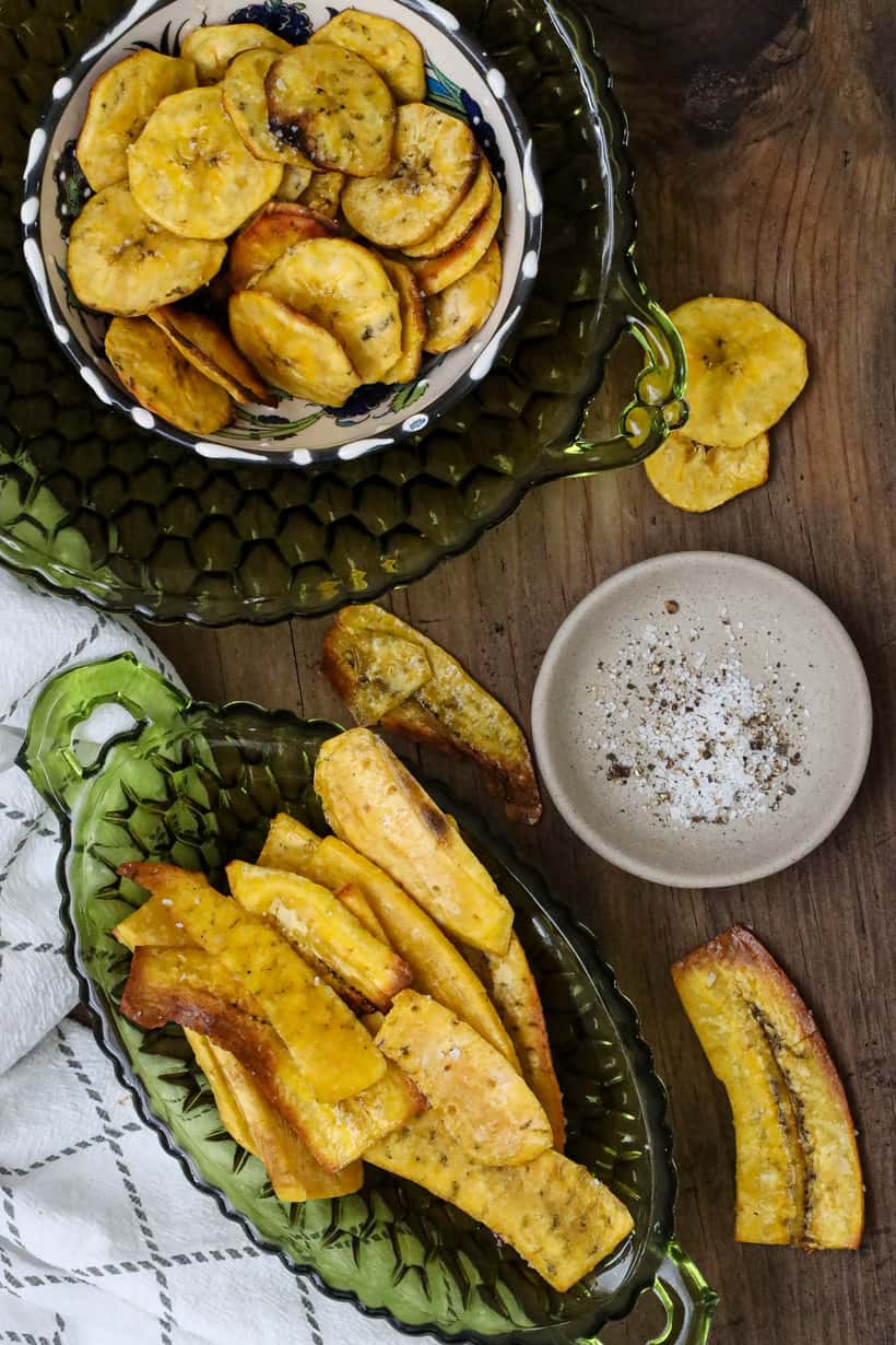 Air Fryer Plantain Chips on wooden board with salt and pepper