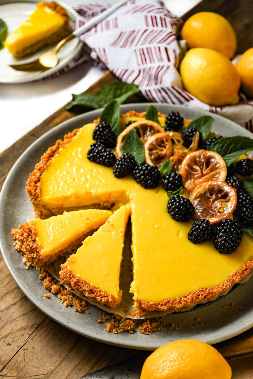 lemon tart with lemon on wooden board