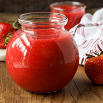 coulis with strawberries on wooden board