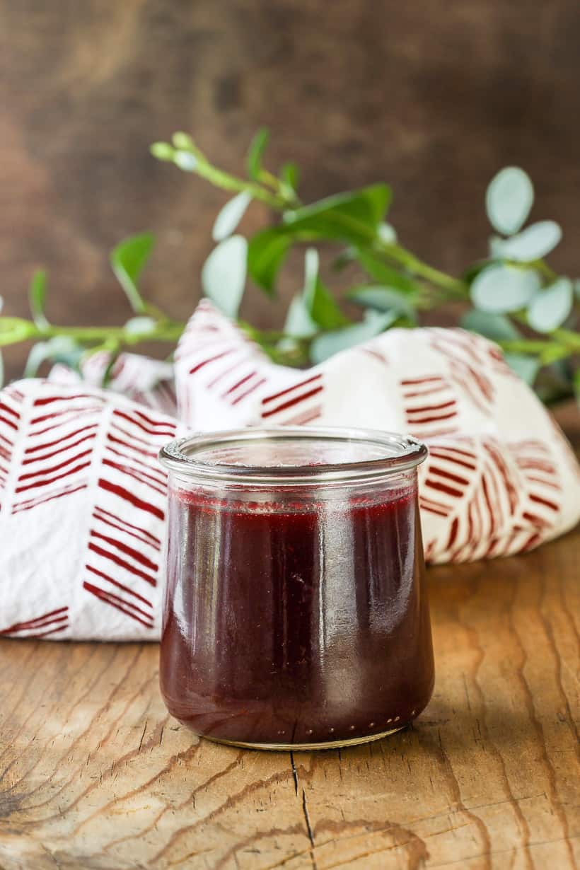 blackberry sauce in a jar on wooden board