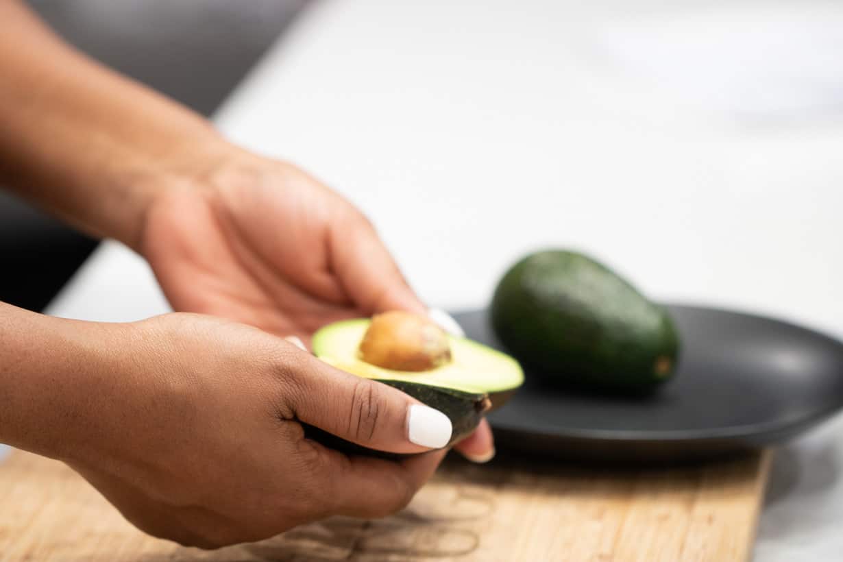 hand separating avocado