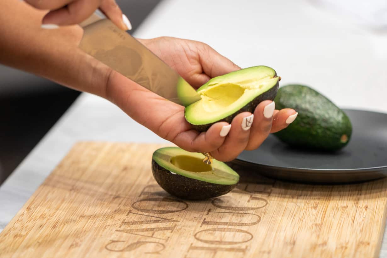 knife slicing avocado.