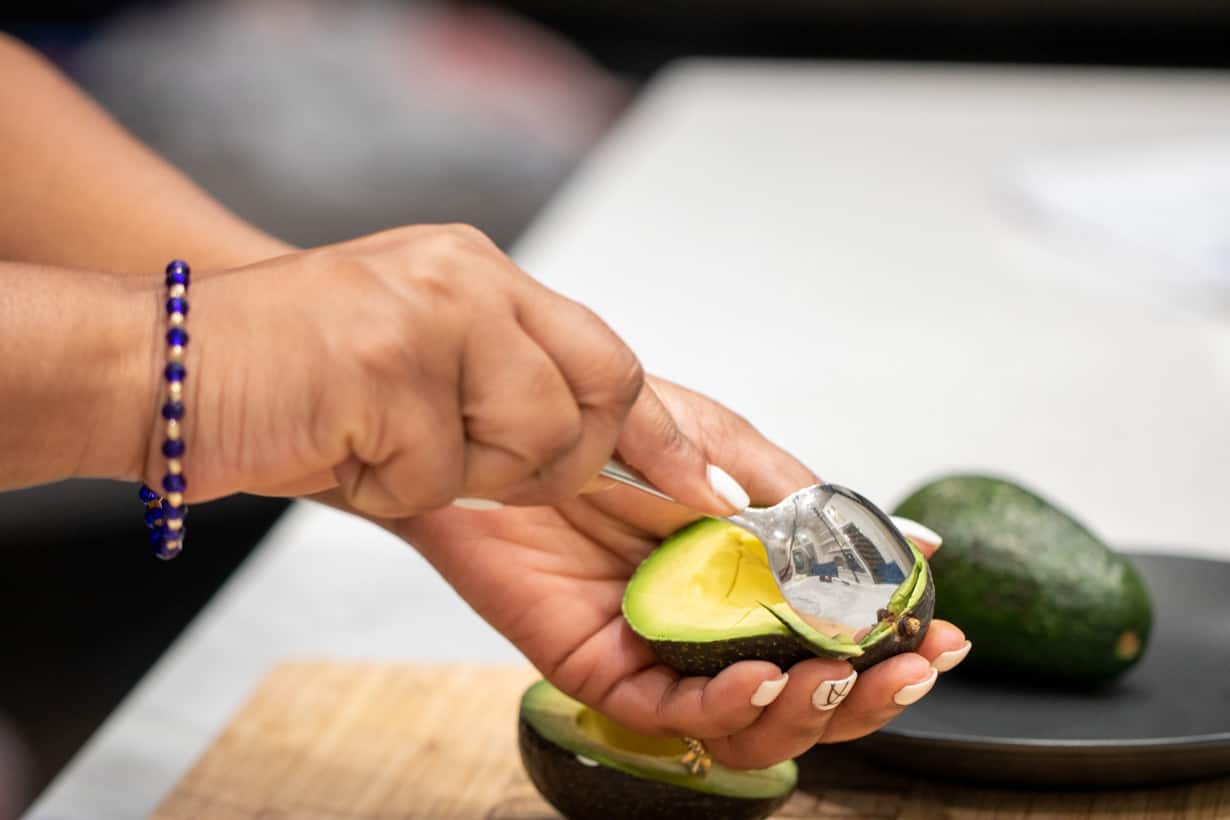 spoon slicing an avocado