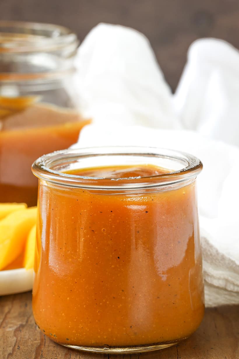 Mango Coulis In Glass Jar on wooden board