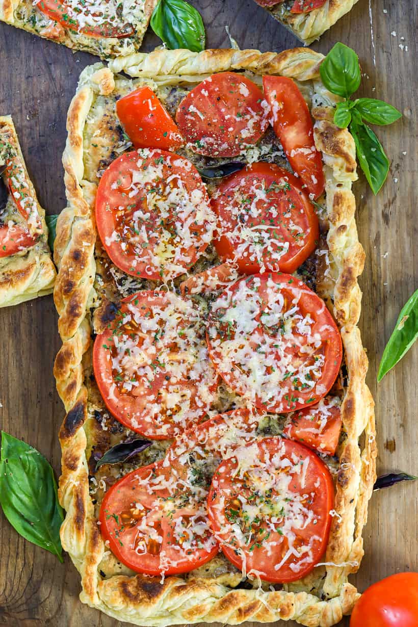 Tomato Tart in the air fryer on a wooden board with fresh herbs