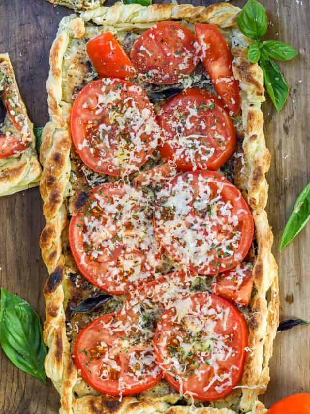 Tomato Tart in the air fryer on a wooden board with fresh herbs