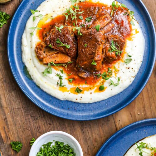 Delicious ribs Guinness recipe in the instant pot on blue plate over mashed potatoes