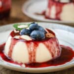 Panna Cotta on plate with shaved almond and blueberries