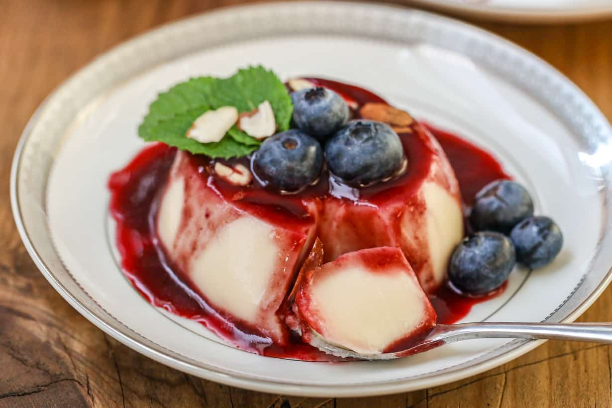 spoon cutout of Panna Cotta on plate