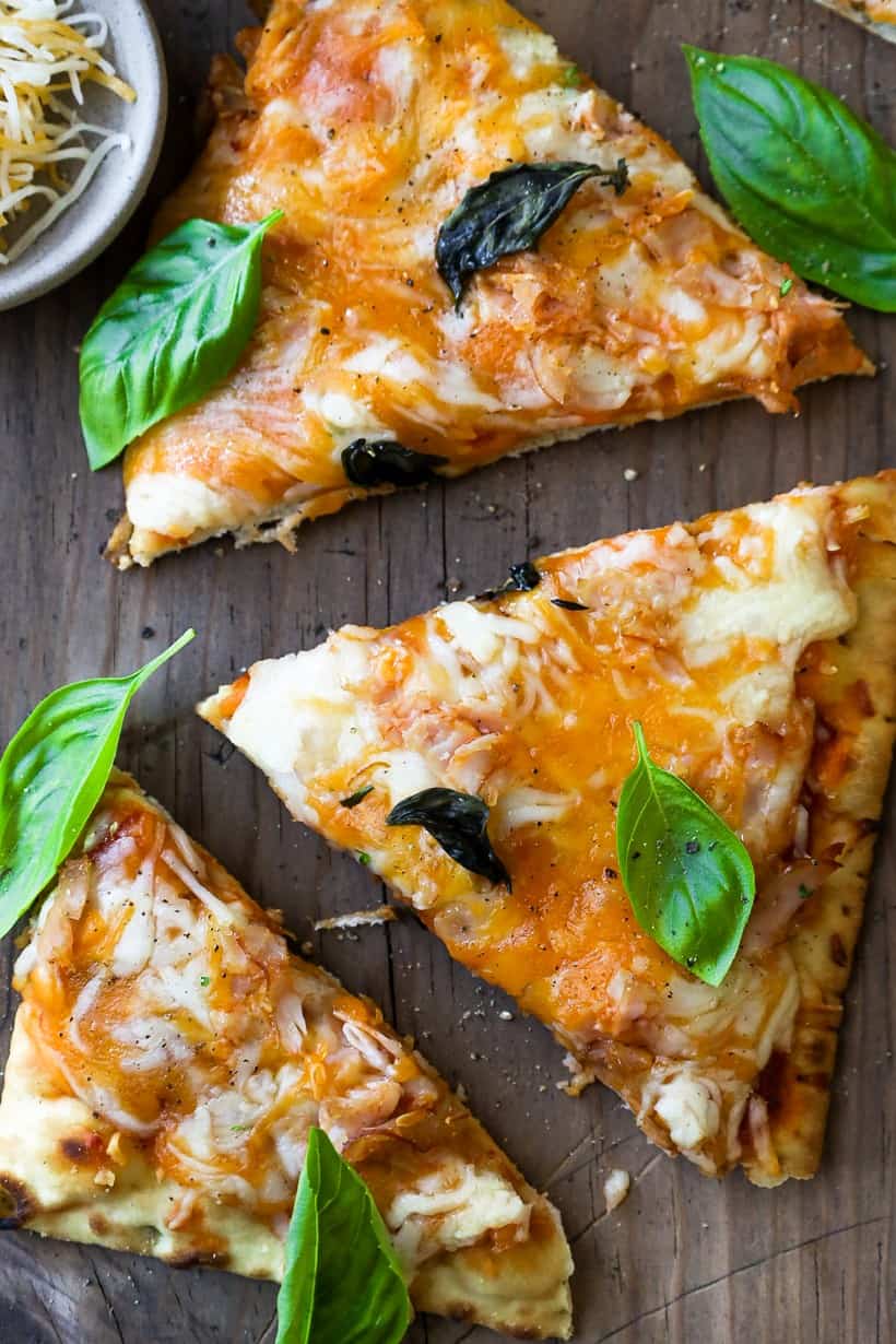 Smoked pizza topped with fresh herbs