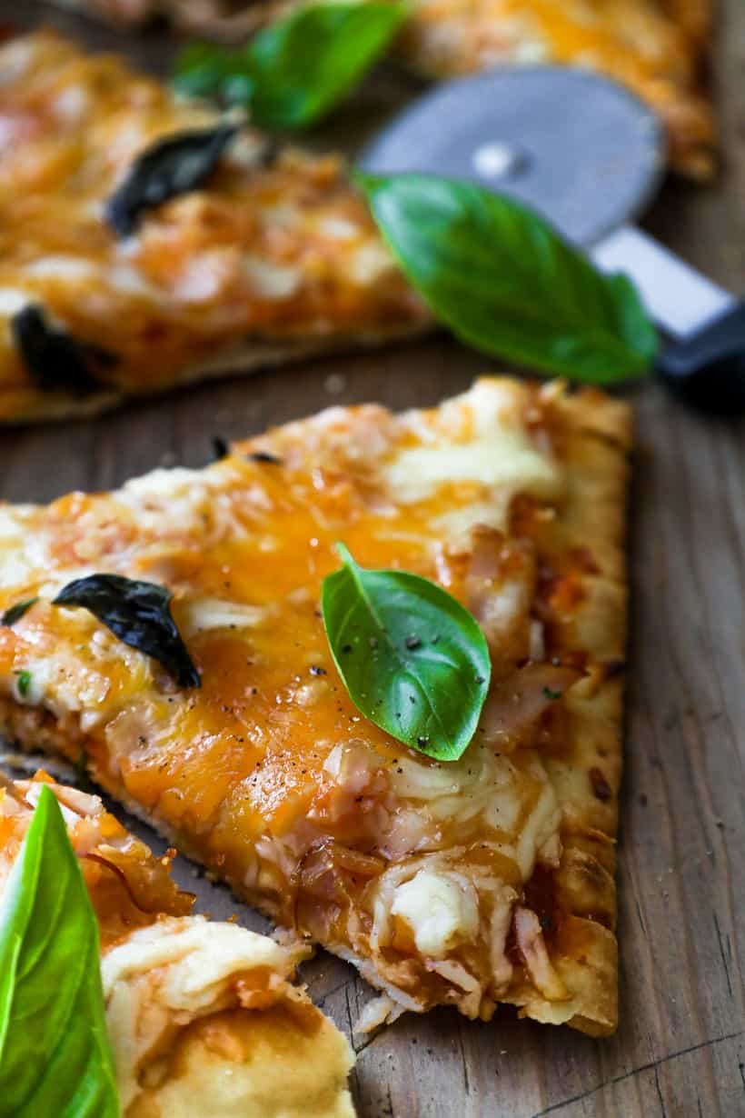 pizza with fresh herbs on board