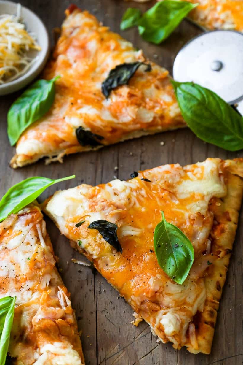 cooked pizza with fresh herbs