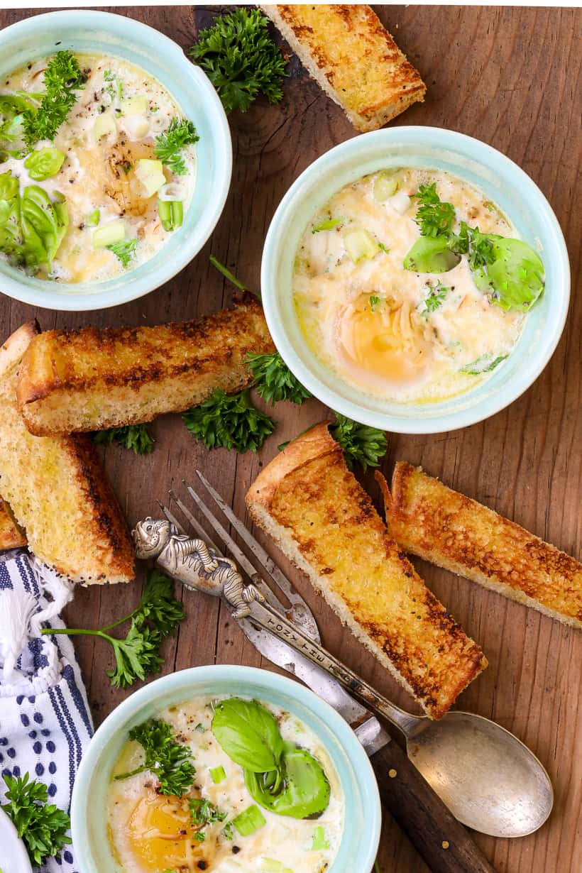 3 ramekins of oven baked eggs and toasted bread