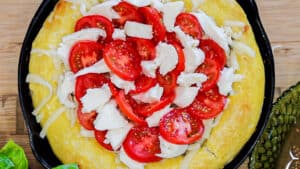 pizza dough topped with cheese and tomatoes