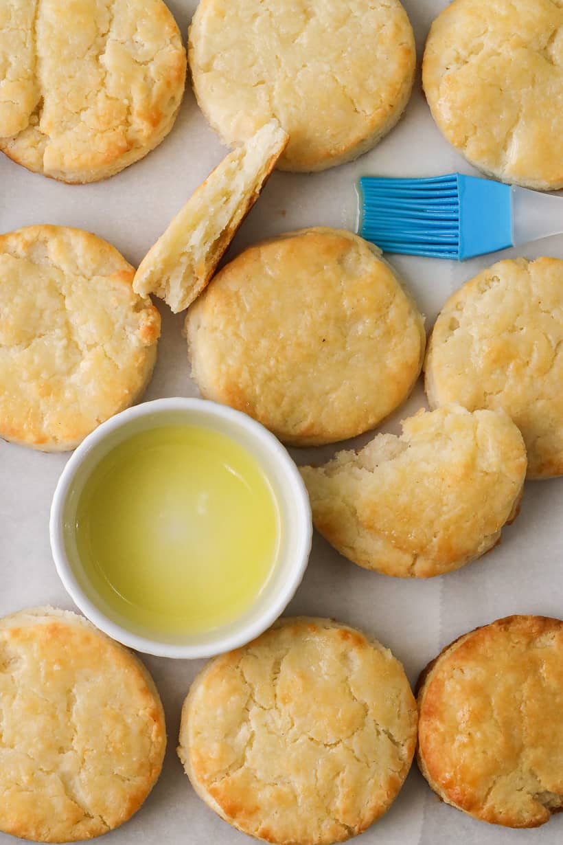 Homemade biscuits in tray with butter and brush