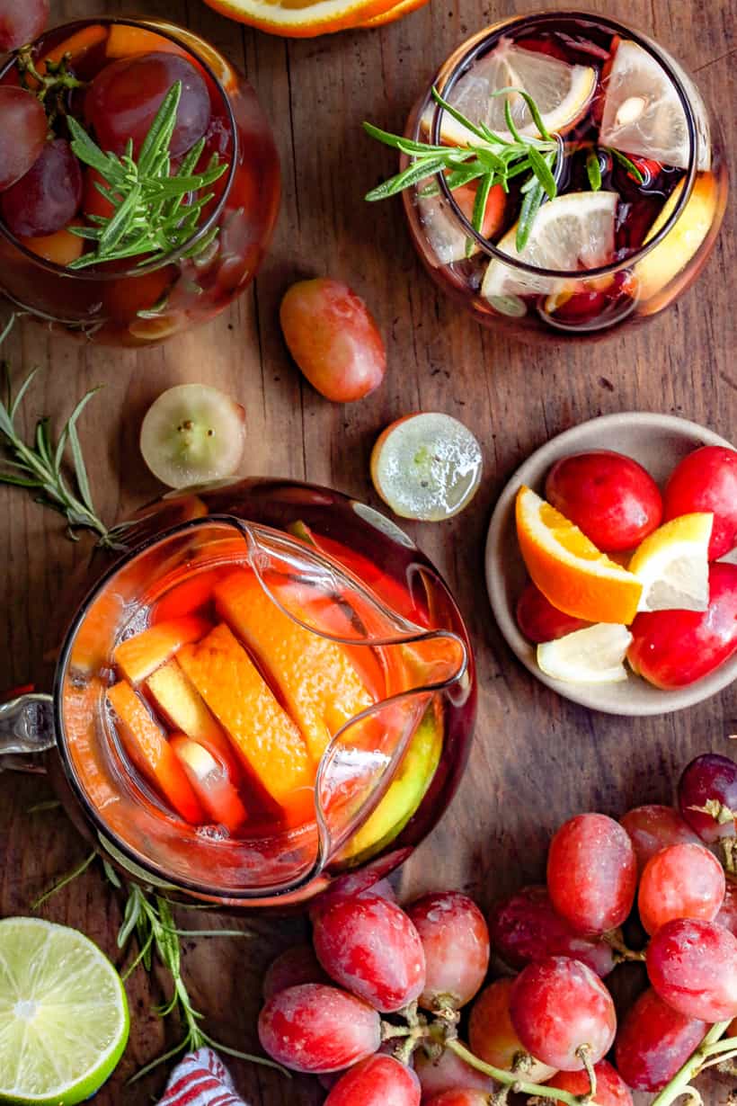 virgin sangria in pitcher and glasses with fruits on board