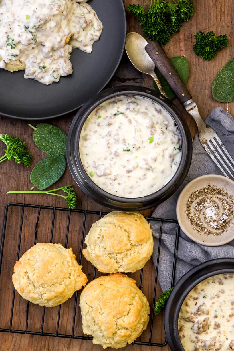gravy in bowl, gravy on top of biscuits, and 3 biscuits on the side