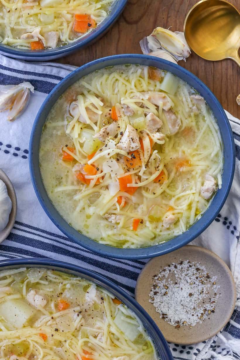 Chicken broth soup in blue bowl