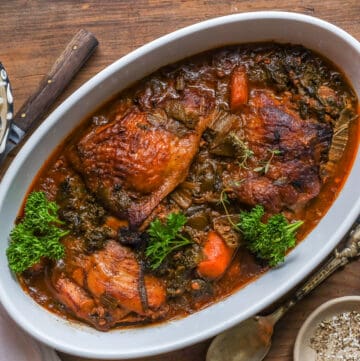kale with chicken in white bowl