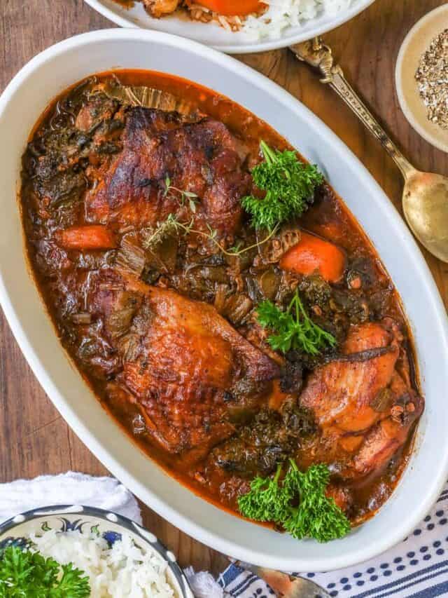 kale stew with chicken and herbs on wooden board