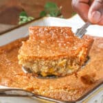 hand lifting corn pudding casserole