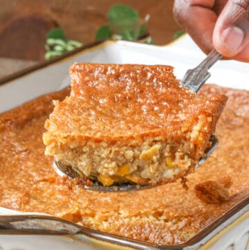 hand lifting corn pudding casserole