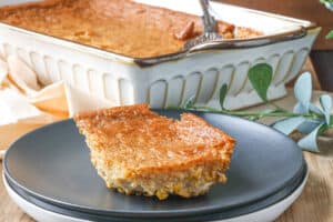 slice of corn pudding casserole on black plate