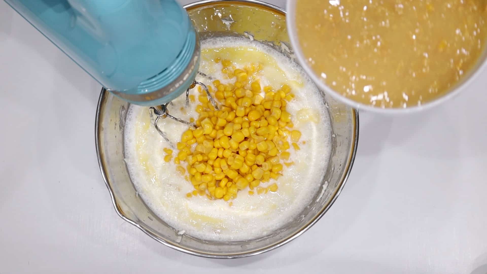adding corn to cream cheese