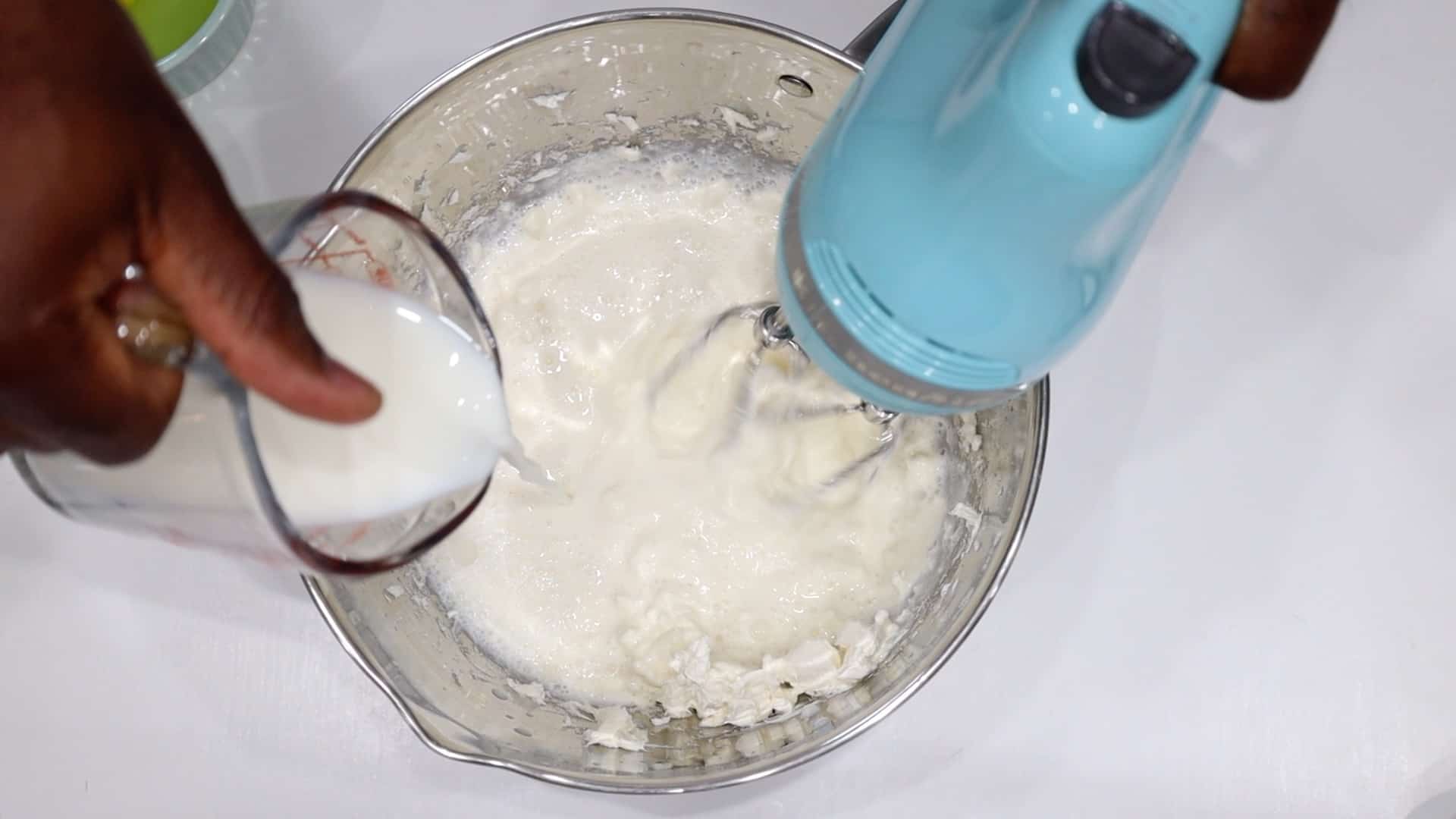 adding milk to cream cheese