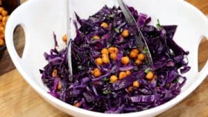 Mixing salad in bowl