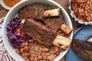 jerk ribs next to rice and cabbage salad