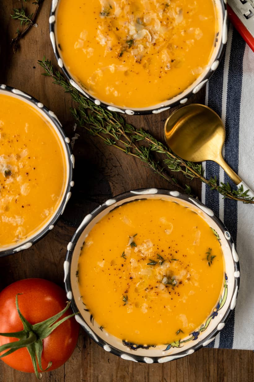 four bowls of tomato bisque and grilled cheese sandwich