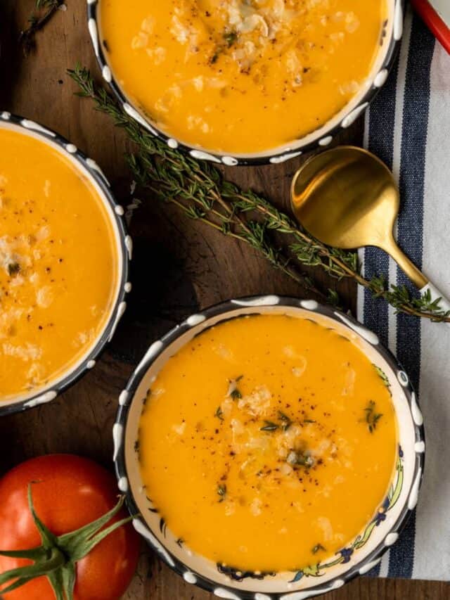 four bowls of tomato bisque and grilled cheese sandwich